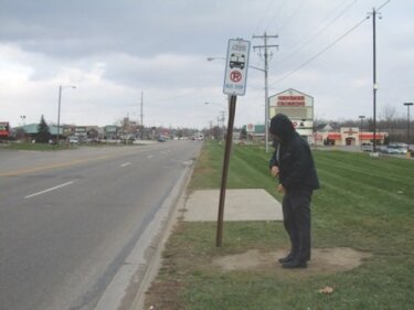 Bus stop without shelter, sidewalks or other amenities in Flint, MI. Image credit: League of Michigan Bicyclists, Flickr 